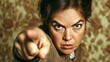 © Iswanto - Close-up portrait of a woman with a stern expression, pointing her finger directly at the viewer.