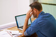© ThurstanBuyout/peopleimages.com - Stress, finance documents and man on laptop in home for budget, financial review and mortgage payment. Thinking, computer and frustrated with paperwork for insurance, investment and bills headache