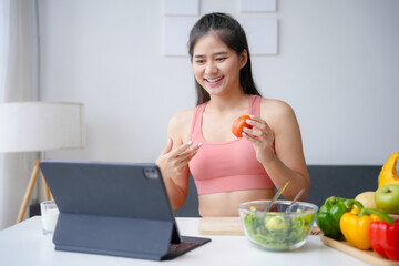 Nutritionist holding tomato. Having video call about healthy food in home kitchen. Discussing nutrition and diet choices. Providing online consultations and advice on wellness and health. Natural