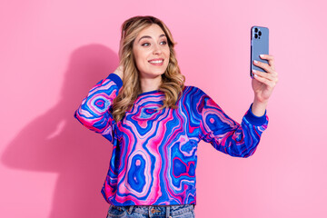 Canvas Print - Portrait photo of blonde curly hair lady wearing bright stylish sweatshirt using phone recording vlog video isolated on pink color background