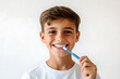 © Oksana_Latysheva - Little boy brushing teeth with a toothbrush isolated on white background