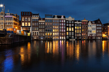 Night city view of Amsterdam canal with dutch houses. Night city view of Amsterdam canal, typical dutch houses and boats,