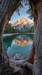 © ME_Photography - A tranquil mountain lake in the Dolomites reflects towering peaks, framed beautifully by an old tree trunk at sunrise.