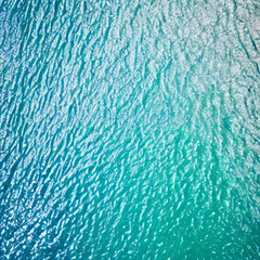 Sticker -  Aerial view beautiful of sea waves from drone. Stock image of blue color of ocean water, sea surface. Top view on turquoise waves, clear water surface texture.