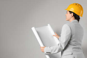 Wall Mural - Engineer in hard hat with draft on grey background, space for text