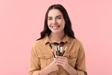 Poster - Beautiful makeup. Smiling woman with brushes on pink background