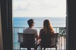 © DK_2020 - A couple sharing a quiet moment on the last day of their vacation, sitting on a balcony with a beautiful view