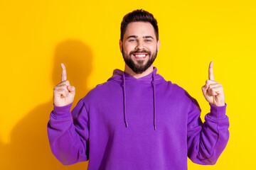 Sticker - Photo of positive stylish nice man wear purple clothes demonstrate empty space banner isolated on yellow color background