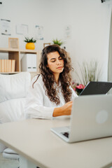 Wall Mural - Young caucasian business woman working in office on laptop