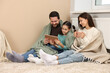 © New Africa - Happy family with tablet near heating radiator at home