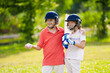 © famveldman - Kids playing cricket in summer park