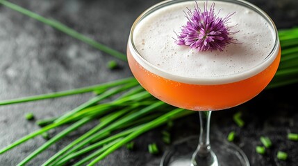   A detailed shot of a drink inside a wine glass with a vibrant purple bloom perched atop it