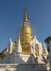 Wall Mural - Whitewashed chedi of Wat Suan Dok covered with bamboo scaffolding in Chiang Mai, Thailand