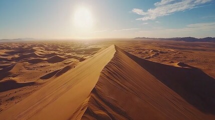 Sticker -   A panoramic photo of a sandy hill amidst the desert under the distant sunbeams filtered through the clouds