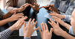 © Pixel-Shot - Group of people putting hands together indoors. Unity concept
