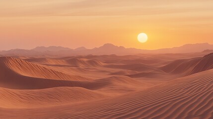   The sun descends beyond a barren landscape featuring sandy hills in the near vicinity and towering mountain ranges in the background