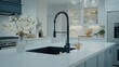 © lililia - A black sink with a modern faucet and blue cabinets creates a sleek, minimalist kitchen atmosphere enhanced by green plants