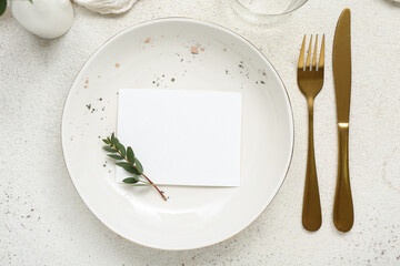 Wall Mural - Plate with gold cutlery and blank card on white grunge background