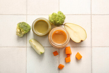 Poster - Glass jars of healthy baby food and ingredients on light tile background