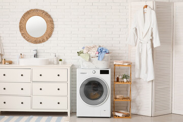 Canvas Print - Basket with dirty clothes near washing machines in laundry room