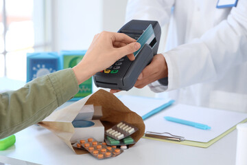 Poster - Male pharmacist receiving payment for medications at pharmacy, closeup