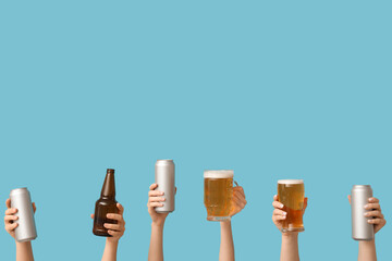 Wall Mural - Female hands with fresh beer in mug, pint, cans and bottle on blue background