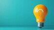 © tanayoch - Bright yellow light bulb on a turquoise background, symbolizing creativity, innovation, and new ideas.