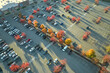 © bilanol - View from above of american grocery store with many parked cars on parking lot with lines and markings for parking places and directions. Place for vehicles in front of a strip mall center