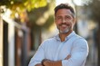 © Dream Canvas - Lifestyle portrait of European middle age mature adult man. Freelancer entrepreneur standing outdoor at street. Happy handsome 40 years old latin hispanic businessman, Generative AI