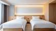© naphat - semi close-up of a modern hotel room with two neatly made beds, minimalistic design featuring light wood and neutral tones, soft lighting and natural daylight from a large window.