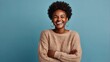 © big bro - Photo of delighted cheerful Afro American woman with crisp hair, points away, shows blank space, happy to advertise item on sale, wears orange jumper