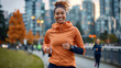 © ifoto - A smiling woman in her late thirties is jogging on the vibrant streets