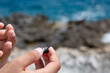 © Alessandro Grandini - Child holding a beetle with the ocean in the background
