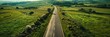 © TheWaterMeloonProjec - Aerial perspective of a roadway traversing expansive rural land.