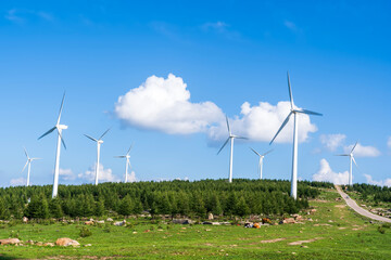 Wind turbines under blue skies and white clouds