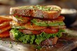 © Boinah - A delicious sandwich stacked with fresh vegetables and herbs on whole grain bread.