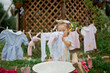 © Anastasiya Krychun - little girl playing  in a garden, washing clothes