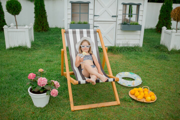 child on the vacation seating in the summer chair 