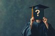 © CozyDigital - University graduate student in graduation robe holds diploma with question mark in front of him. What to do after graduating from university