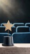 © pvl0707 - A shining golden star award on a wooden table in front of an elegant cinema hall with empty seats
