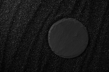 Top view black sand texture background. Dark Sand macro photography