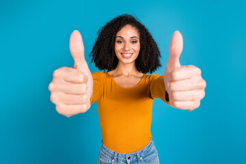 Sticker - Photo portrait of attractive young woman thumb up approve dressed stylish orange clothes isolated on blue color background