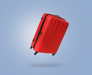 Wall Mural - Red suitcase in air on light blue background