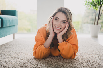 Canvas Print - Portrait of nice young girl relax lying floor dreamy wear orange clothes modern interior flat indoors