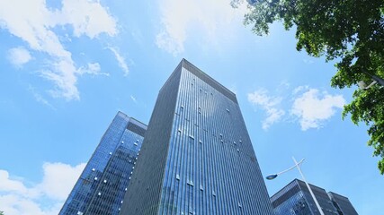 Canvas Print - Time lapse of modern office buildings under blue sky