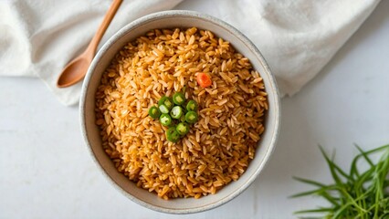 Top above view of white bowl full of brown rice placed on wooden table. Copy space, healthy organic cooked cereal, traditional Asian or Chinese Japan cuisine, lunch or dinner meal food