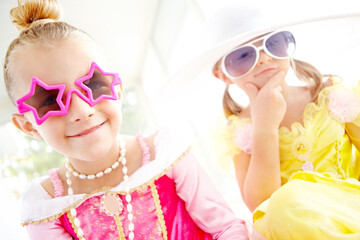 Princess, friends and portrait of children together in home with fun, glamour and confidence for character play. Fancy, dress and happy girl kids with smile, fantasy costume and creative development.