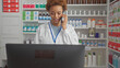 © Krakenimages.com - Smiling african american woman pharmacist consulting on phone in drugstore