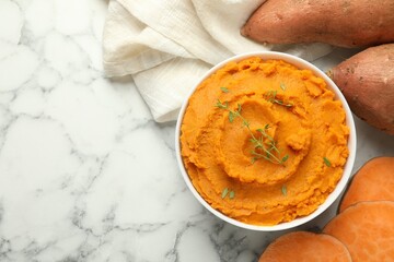 Wall Mural - Delicious mashed sweet potatoes in bowl, microgreens and vegetables on white marble table, top view. Space for text