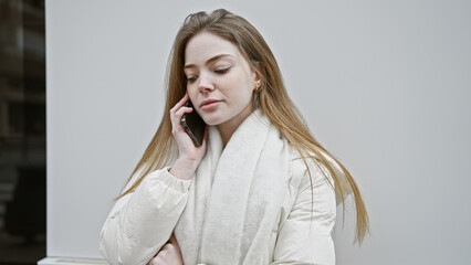 Poster - A young blonde woman talks on the phone on a city street, exemplifying urban communication.